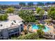 Aerial view showing a community pool with lounge chairs and lush landscaping surrounding the area at 5221 N 24Th St # 103, Phoenix, AZ 85016