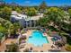 Aerial view showcasing lush landscaping and a sparkling community pool, complete with lounge seating at 5221 N 24Th St # 103, Phoenix, AZ 85016