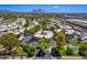 Gorgeous aerial view of tree-lined streets and lush landscaping in a well-maintained residential area with mountain views at 5221 N 24Th St # 103, Phoenix, AZ 85016