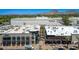 An aerial view highlighting upscale retail stores and dining establishments in a bustling outdoor shopping center at 5221 N 24Th St # 103, Phoenix, AZ 85016