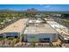Aerial view of a shopping center with a Macy's store, set against a backdrop of mountains on a clear, sunny day at 5221 N 24Th St # 103, Phoenix, AZ 85016