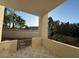 A cozy balcony with patterned tile flooring and views of lush greenery at 5221 N 24Th St # 103, Phoenix, AZ 85016