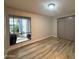 Bedroom with wood-look flooring and a large window, providing natural light at 5221 N 24Th St # 103, Phoenix, AZ 85016