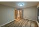 Neutral bedroom with wood-look flooring, large closet, and access to bathroom at 5221 N 24Th St # 103, Phoenix, AZ 85016