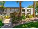 Serene building exterior featuring a decorative bridge, mature trees, and tranquil water feature at 5221 N 24Th St # 103, Phoenix, AZ 85016