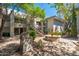Exterior view of condos in a landscaped courtyard with fountain and barbecue at 5221 N 24Th St # 103, Phoenix, AZ 85016