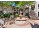 Community courtyard featuring a fountain, landscaped seating, and building access stairs at 5221 N 24Th St # 103, Phoenix, AZ 85016