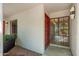 Condo entrance featuring a red door with sidelight, adjacent window, and unit number at 5221 N 24Th St # 103, Phoenix, AZ 85016