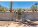 Stylish entrance gate with decorative design, charming brick pathway, and shaded bench seating at 5221 N 24Th St # 103, Phoenix, AZ 85016