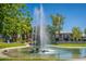 Water fountain on a green lawn with buildings in the background creates a serene environment at 5221 N 24Th St # 103, Phoenix, AZ 85016
