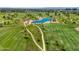 Scenic aerial view of a lush golf course with a tranquil pond and meandering paths at 5221 N 24Th St # 103, Phoenix, AZ 85016