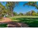 Scenic golf course view with lush green grass, mature trees, and clear blue skies in a desirable community at 5221 N 24Th St # 103, Phoenix, AZ 85016