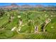 Aerial view of lush golf course with mountain views, sand traps, and fairways at 5221 N 24Th St # 103, Phoenix, AZ 85016
