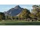 Golf course scenery with golfers, golf carts, and mountain views at 5221 N 24Th St # 103, Phoenix, AZ 85016