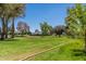 Expansive green space with mature trees and a walking path under a clear blue sky at 5221 N 24Th St # 103, Phoenix, AZ 85016