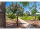 Scenic view of a well-maintained green space with a paved pathway, lush landscaping, and mature trees at 5221 N 24Th St # 103, Phoenix, AZ 85016