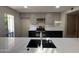 Updated kitchen with grey cabinets, black appliances, and modern backsplash at 5221 N 24Th St # 103, Phoenix, AZ 85016