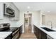 Modern kitchen with stainless steel appliances, sleek countertops, and view into other rooms at 5221 N 24Th St # 103, Phoenix, AZ 85016