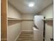 Bright laundry room featuring a stacked washer and dryer and ample shelving at 5221 N 24Th St # 103, Phoenix, AZ 85016