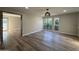 Open living room with wood-look floors, neutral paint, and natural light from two large windows at 5221 N 24Th St # 103, Phoenix, AZ 85016