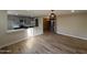 Open-concept living area featuring updated kitchen, wood flooring, and modern light fixture at 5221 N 24Th St # 103, Phoenix, AZ 85016