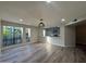 Bright living room with wood-look floors and a view of lush greenery at 5221 N 24Th St # 103, Phoenix, AZ 85016