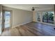 Bright living room featuring wood-look floors, neutral walls, and large windows with natural light at 5221 N 24Th St # 103, Phoenix, AZ 85016