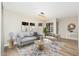Bright living room featuring a modern couch, stylish decor, and a large window to let in natural light at 5221 N 24Th St # 103, Phoenix, AZ 85016