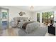Stylized main bedroom featuring a large bed, modern furniture, and ample natural light from the windows at 5221 N 24Th St # 103, Phoenix, AZ 85016
