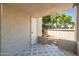 Enclosed patio featuring a geometric tile floor and privacy wall with views of lush landscaping at 5221 N 24Th St # 103, Phoenix, AZ 85016