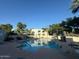 Enjoy community living with a sparkling pool, lounge chairs, and relaxing shade at 5221 N 24Th St # 103, Phoenix, AZ 85016