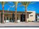 Adobe Bar & Grille exterior features a stone facade, palm trees, and patio seating at 5221 N 24Th St # 103, Phoenix, AZ 85016