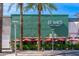 Blanco Tacos + Tequila with palm trees and red umbrellas providing shade along the exterior at 5221 N 24Th St # 103, Phoenix, AZ 85016