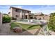 A well-maintained backyard with a pool, seating, and rock features at 5423 W Michigan Ave, Glendale, AZ 85308