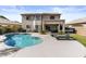 Backyard showcasing a pool with lounge chairs and well manicured lawn at 5423 W Michigan Ave, Glendale, AZ 85308