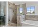 Tiled bathroom with tub, shower, and neutral accents at 5423 W Michigan Ave, Glendale, AZ 85308