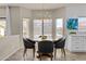 Cozy dining area with modern chandelier, round table, and large windows for ample natural light at 5423 W Michigan Ave, Glendale, AZ 85308