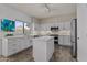 Well-lit kitchen featuring white cabinets, granite countertops and stainless steel appliances at 5423 W Michigan Ave, Glendale, AZ 85308
