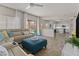 Spacious living area with tile floors that leads into an open kitchen and large glass sliding doors at 5423 W Michigan Ave, Glendale, AZ 85308