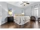 Cozy main bedroom featuring a ceiling fan, hardwood floors, and stylish bedside lamps for a relaxing atmosphere at 5423 W Michigan Ave, Glendale, AZ 85308