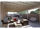 Inviting back patio featuring an outdoor seating area and string lights for relaxed evenings at 546 S Ellsworth Rd, Mesa, AZ 85208