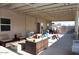 Covered back patio with ample seating and outdoor amenities perfect for entertaining at 546 S Ellsworth Rd, Mesa, AZ 85208