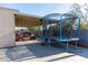 Expansive backyard featuring a trampoline and covered patio, perfect for Gathering fun and relaxation at 546 S Ellsworth Rd, Mesa, AZ 85208
