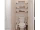 Clean half-bathroom featuring toilet and decor shelves at 546 S Ellsworth Rd, Mesa, AZ 85208