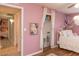 This bedroom has hardwood floors, pink walls and features unique hanging decoration and window at 546 S Ellsworth Rd, Mesa, AZ 85208