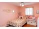 Charming bedroom featuring hardwood floors, pink walls, a ceiling fan, and a whimsical, personalized decor at 546 S Ellsworth Rd, Mesa, AZ 85208