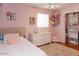 Charming bedroom with plush bedding, closet storage, and cute decorative accents at 546 S Ellsworth Rd, Mesa, AZ 85208
