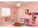 This bedroom has light pink walls and features a window, toys, closet, and colorful accents at 546 S Ellsworth Rd, Mesa, AZ 85208