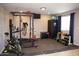 Home exercise room with weight lifting equipment, offering a convenient and private fitness space at 546 S Ellsworth Rd, Mesa, AZ 85208
