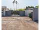 Rear exterior showcasing a private gated parking area and ample outdoor space at 546 S Ellsworth Rd, Mesa, AZ 85208